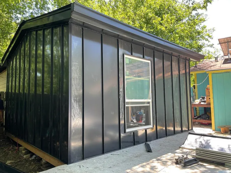 Black standing seam metal wall panels for Roof Inspection in East End